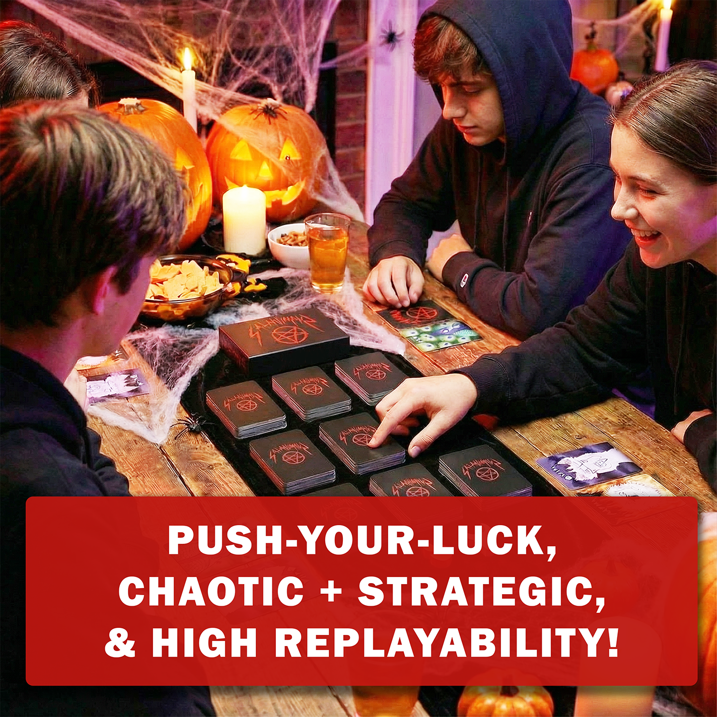 People playing a Halloween board game, SATANIMALS, with pumpkins and candles