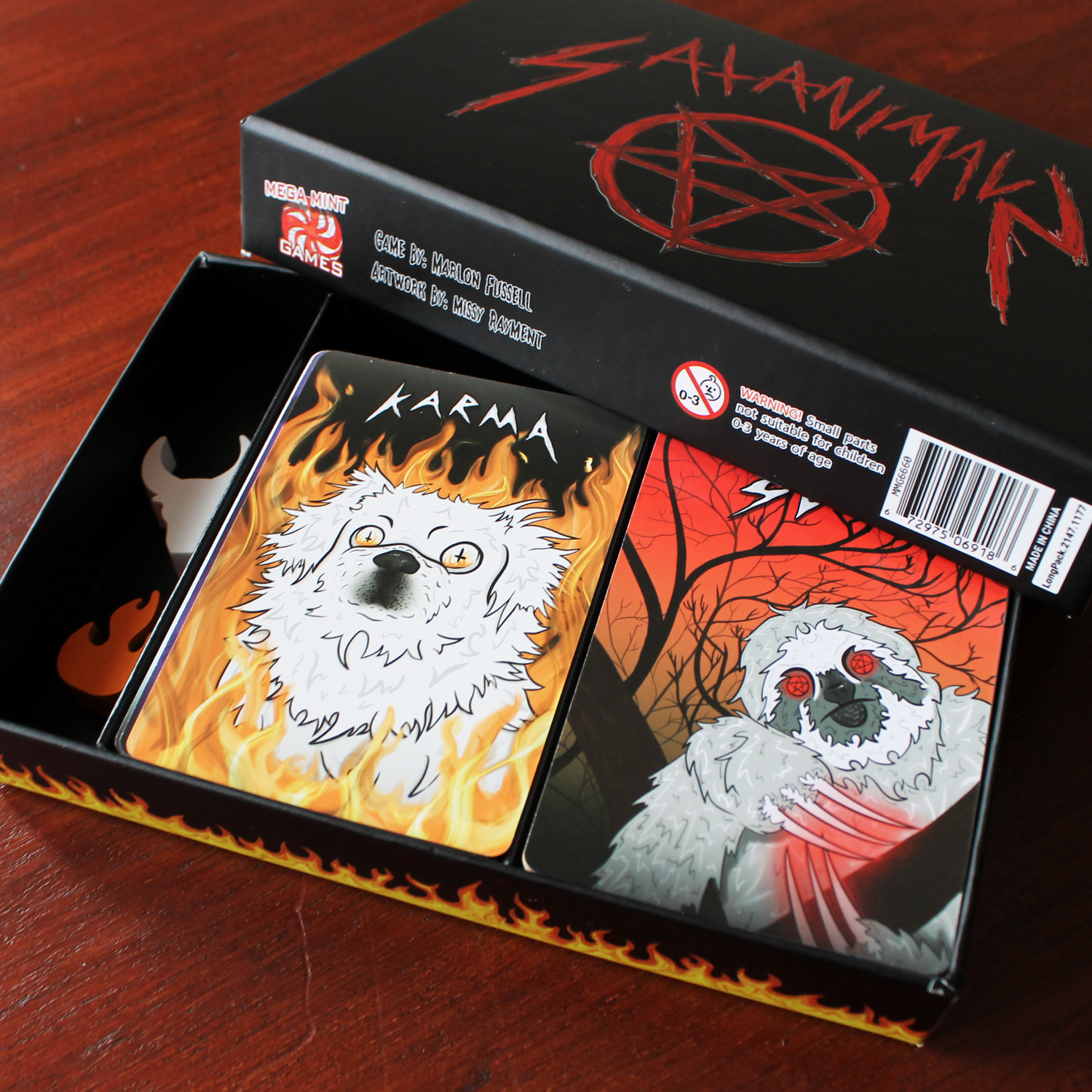 SATANIMALS, satanic-themed card game box interior with cards featuring dog and sloth